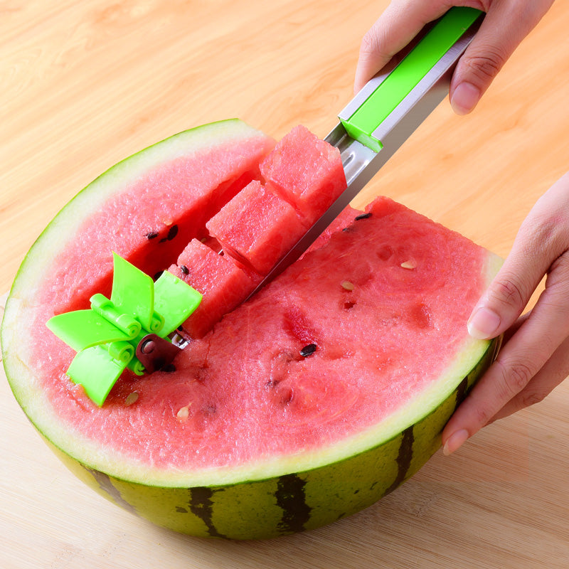 A person cutting a Windmill Watermelon Slicer.