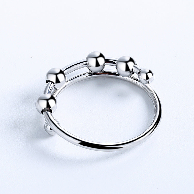 Three Fidget Beads Rings with balls on them.