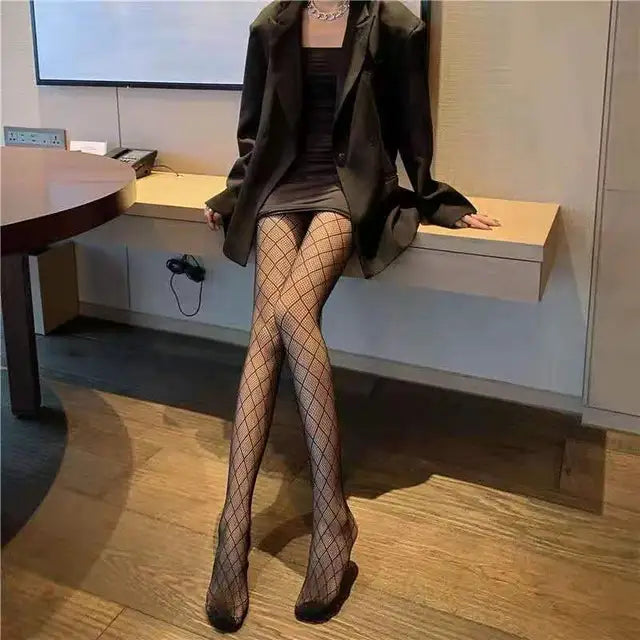 A rebellious woman wearing Edgy Elegance fishnet stockings and black boots.