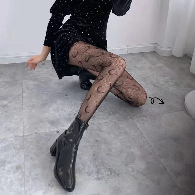 A rebellious woman wearing Edgy Elegance fishnet stockings and black boots.