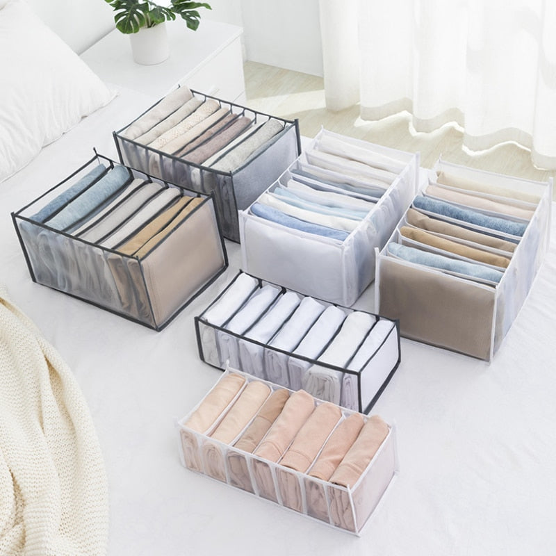 A woman is putting clothes in a ModernMazing Wardrobe Clothes Organizer.