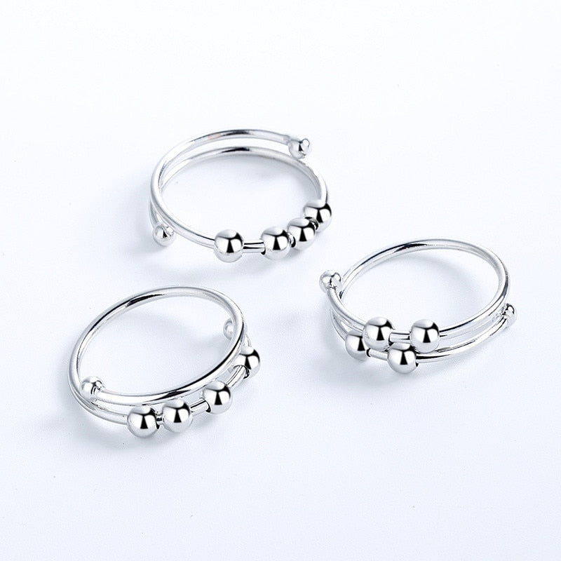 Three Fidget Beads Rings with balls on them.