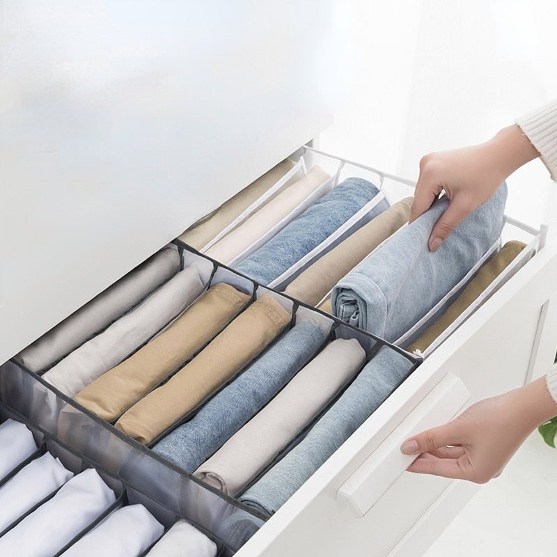 A woman is putting clothes in a ModernMazing Wardrobe Clothes Organizer.