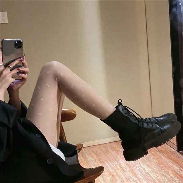 A sensuous woman wearing Seductive Silhouette Faux Thigh High Stockings and black shoes.