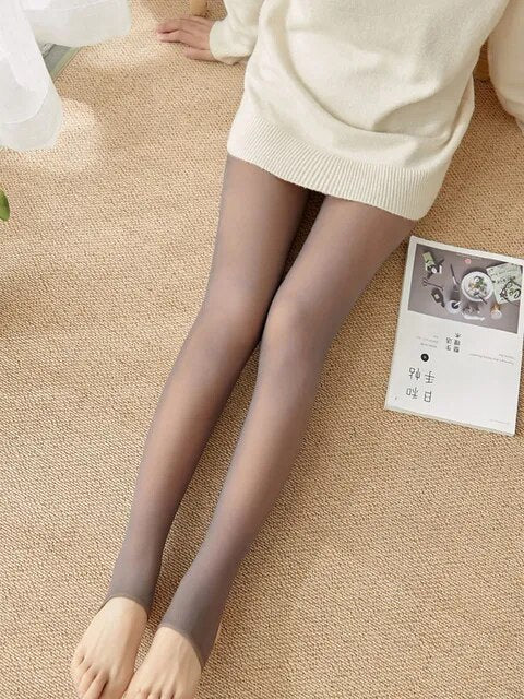 Two women are sitting stylishly on a wooden floor wearing Sheer Warmth: Women's Winter Leggings.