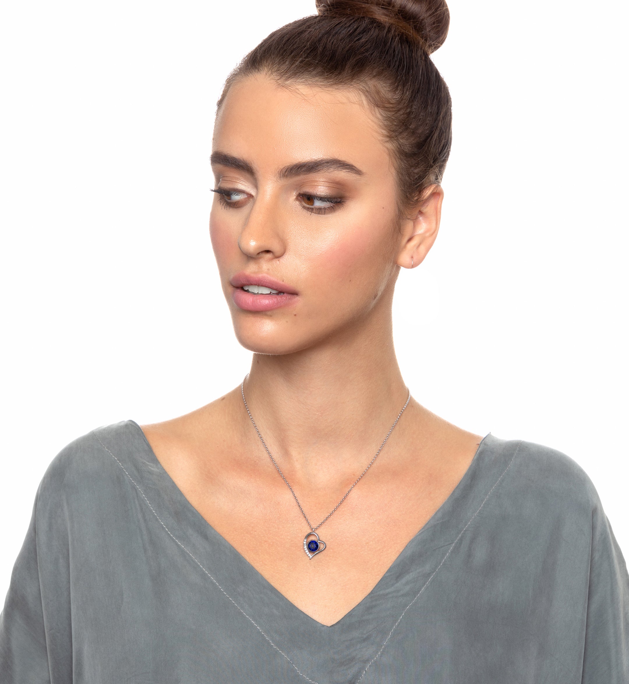 Close-up of a 925 Sterling Silver I Love You Heart Pendant Necklace with a blue gemstone inscribed with "i love you" in multiple languages, perfect as an anniversary gift.