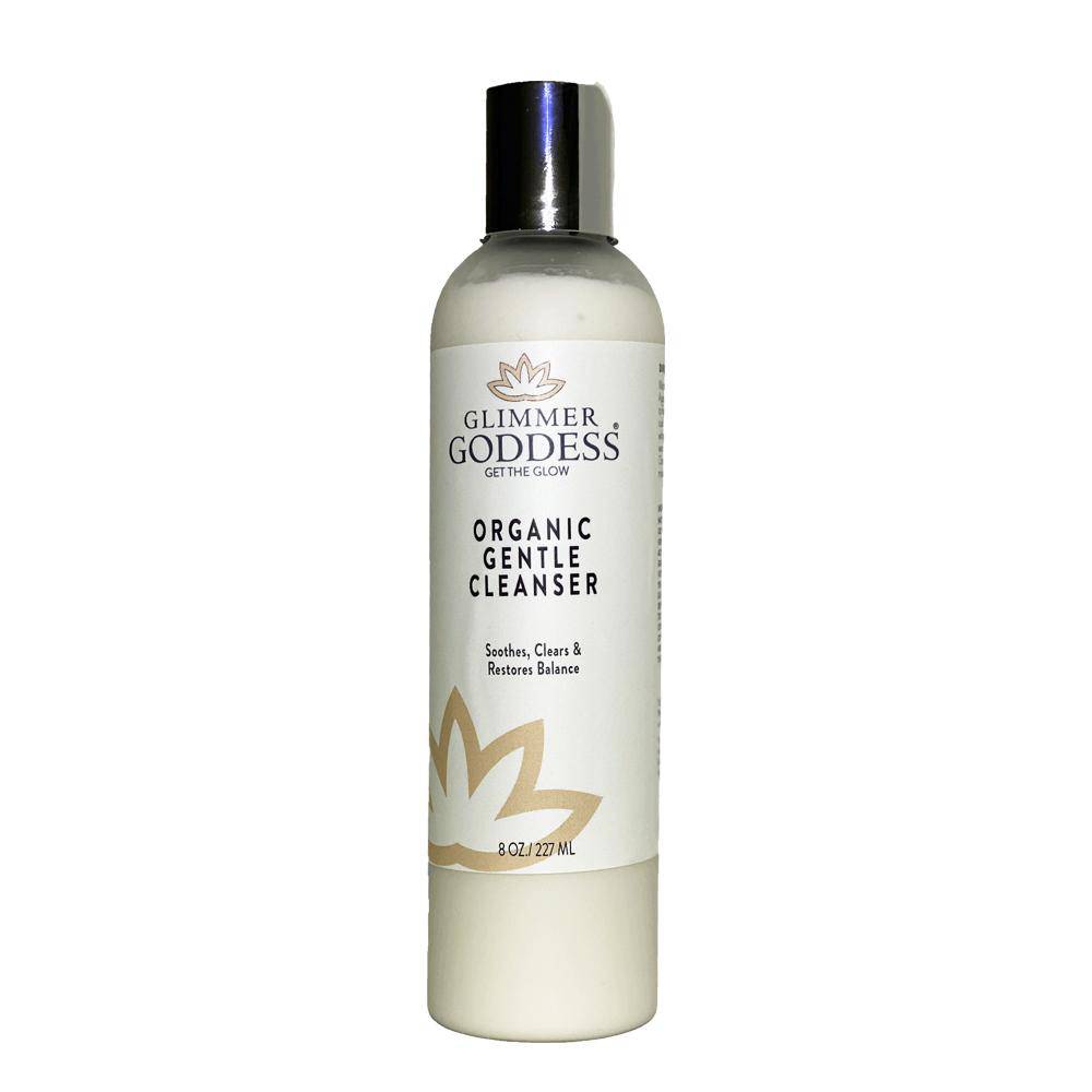 A bottle of Organic Skin Renewal Gentle Cleanser with a white label and black cap, text noting it soothes, cleans, restores, and enhances skin firmness. 8 oz size.
