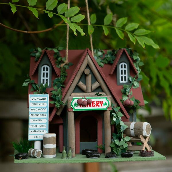 A Songbird Valley Cottage Winery Birdhouse with a winery sign on it.