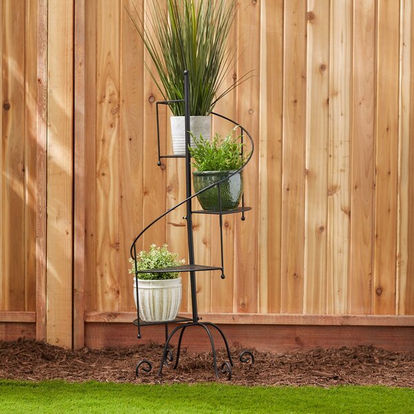 A Summerfield Terrace Iron Spiral Staircase Plant Stand with two shelves.