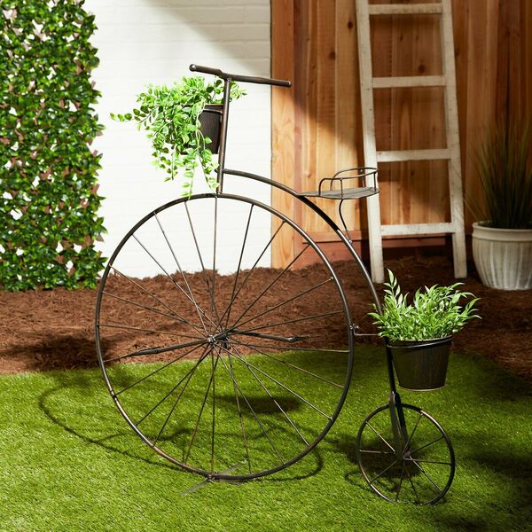 A Summerfield Terrace Vintage-Style Bicycle Plant Stand with a flower pot on it.