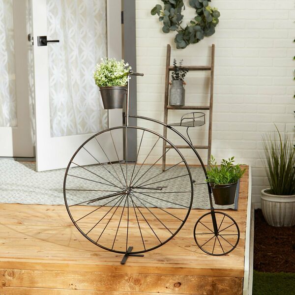 A Summerfield Terrace Vintage-Style Bicycle Plant Stand with a flower pot on it.