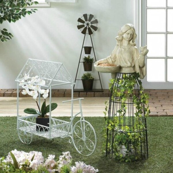 A Summerfield Terrace White Iron Tricycle Plant Cart with a white house on it.