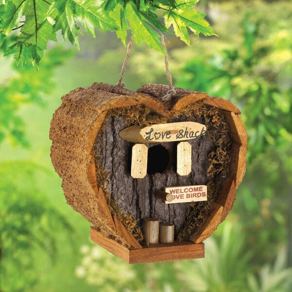 A Songbird Valley Heart-Shaped Love Shack Mini Bird House with a surfboard on it.