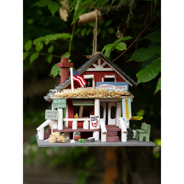 A Songbird Valley Wood Country Store Bird House with an american flag on it.