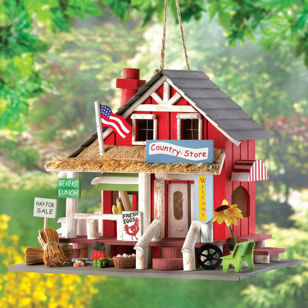 A Songbird Valley Wood Country Store Bird House with an american flag on it.