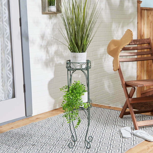 A Summerfield Terrace Scrolled Verdigris Two-Level Plant Stand with two tiers.