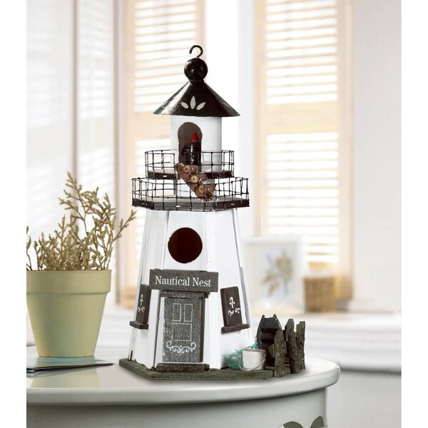 A Songbird Valley Nautical Nest Wood Lighthouse Bird House with a lighthouse on it.