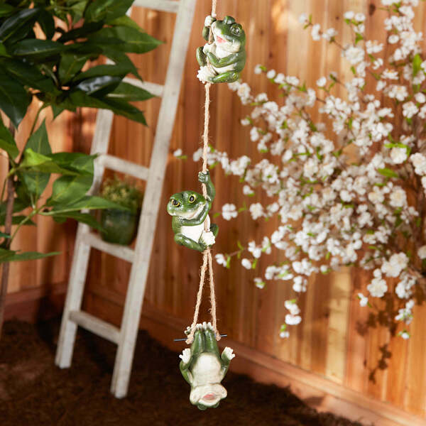 Three Summerfield Terrace Happy Frogs Hanging Decor hanging from a string on a white background.