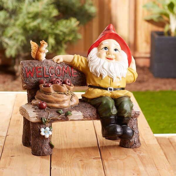 A Summerfield Terrace Garden Gnome and Squirrel on Welcome Bench sitting on a log with a welcome sign.