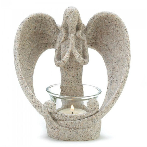 A Wings of Devotion Sand-Look Angelic Candle Holder with an angel holding a candle.