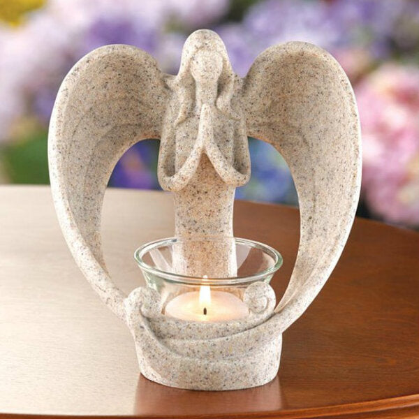 A Wings of Devotion Sand-Look Angelic Candle Holder with an angel holding a candle.