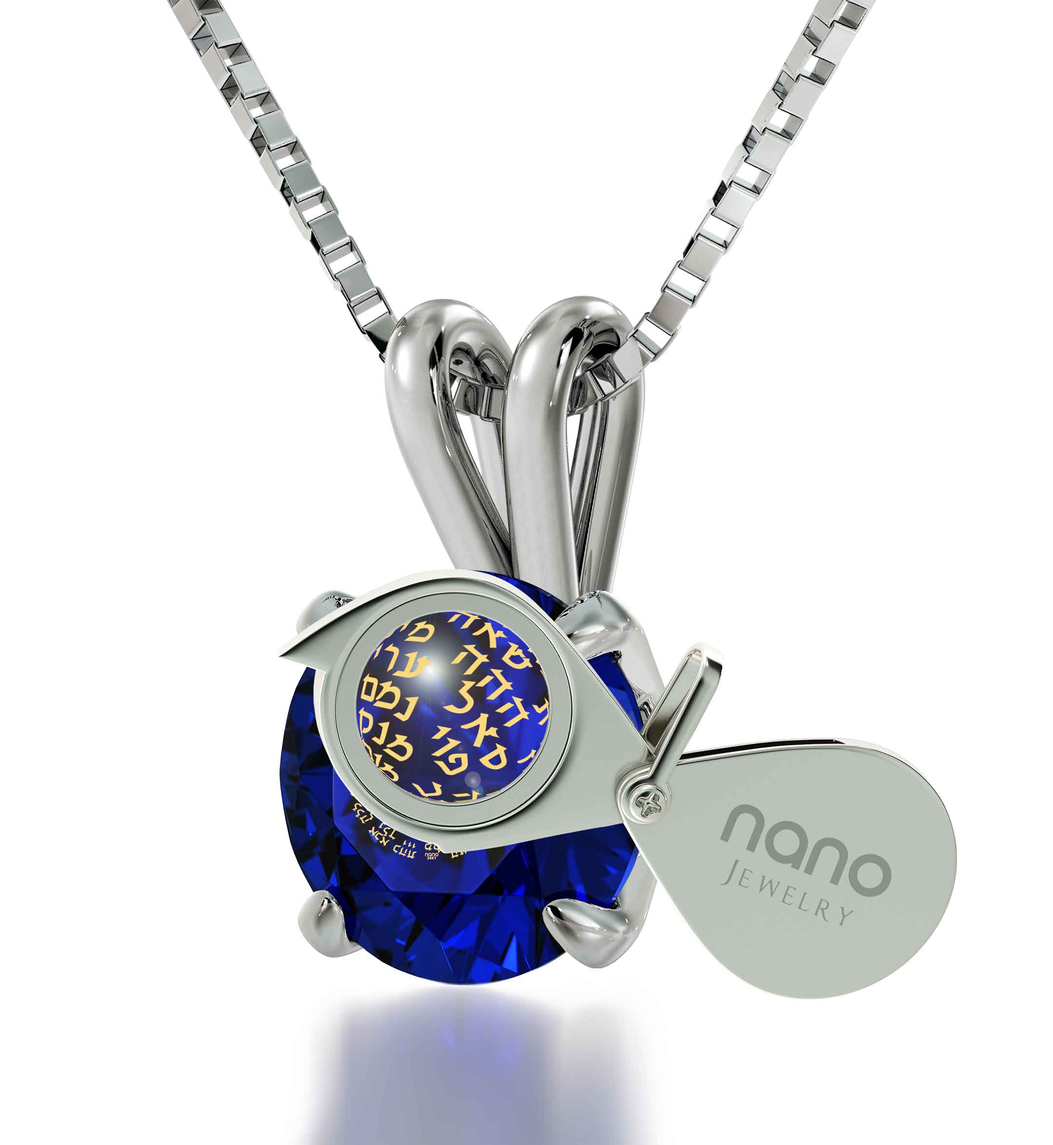 A large blue Swarovski crystal held by a 925 sterling silver claw setting, with intricate golden Hebrew script visible inside the 925 Sterling Silver Kabballah Necklace 72 Names Solitaire Pendant 24k Gold Inscribed.