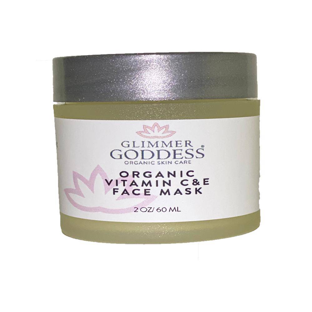 A jar of Organic Vitamin C & E Brightening & Tightening Face Mask - 2 oz., featuring a label with a pink lotus flower logo.