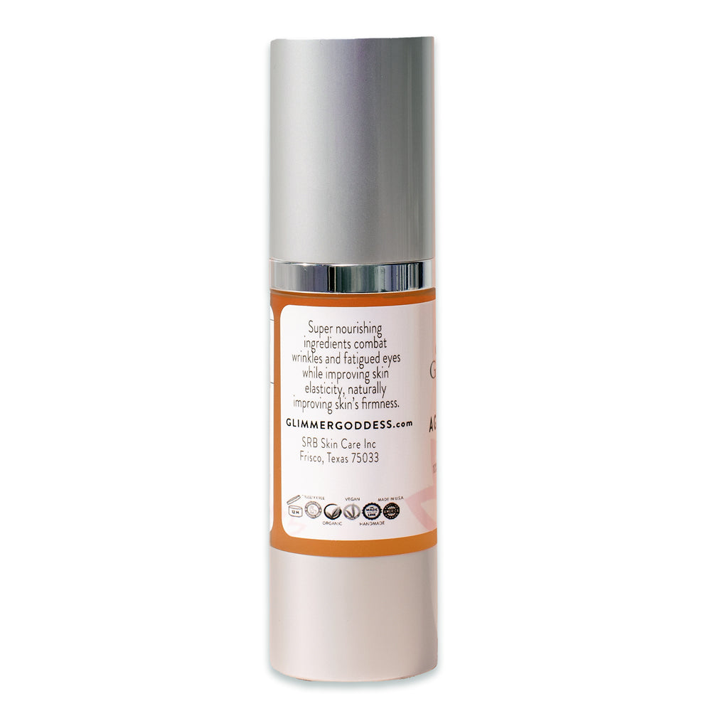 A bottle of Organic Age Reversing Eye Serum - Instantly Firms with pink and silver packaging, highlighting ingredients like Kakadu plum, hyaluronic acid, and Vitamin C.