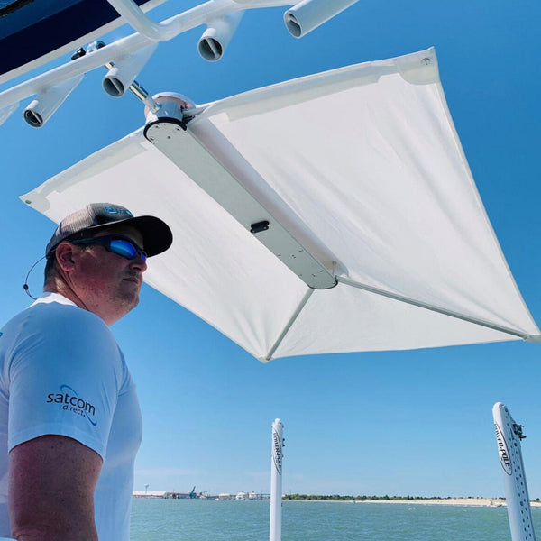 A TACO ShadeFin w/Black Fabric, Bag & Fixed Rod Holder Mount Kit and a black umbrella provide shade and sun protection during boat trips.