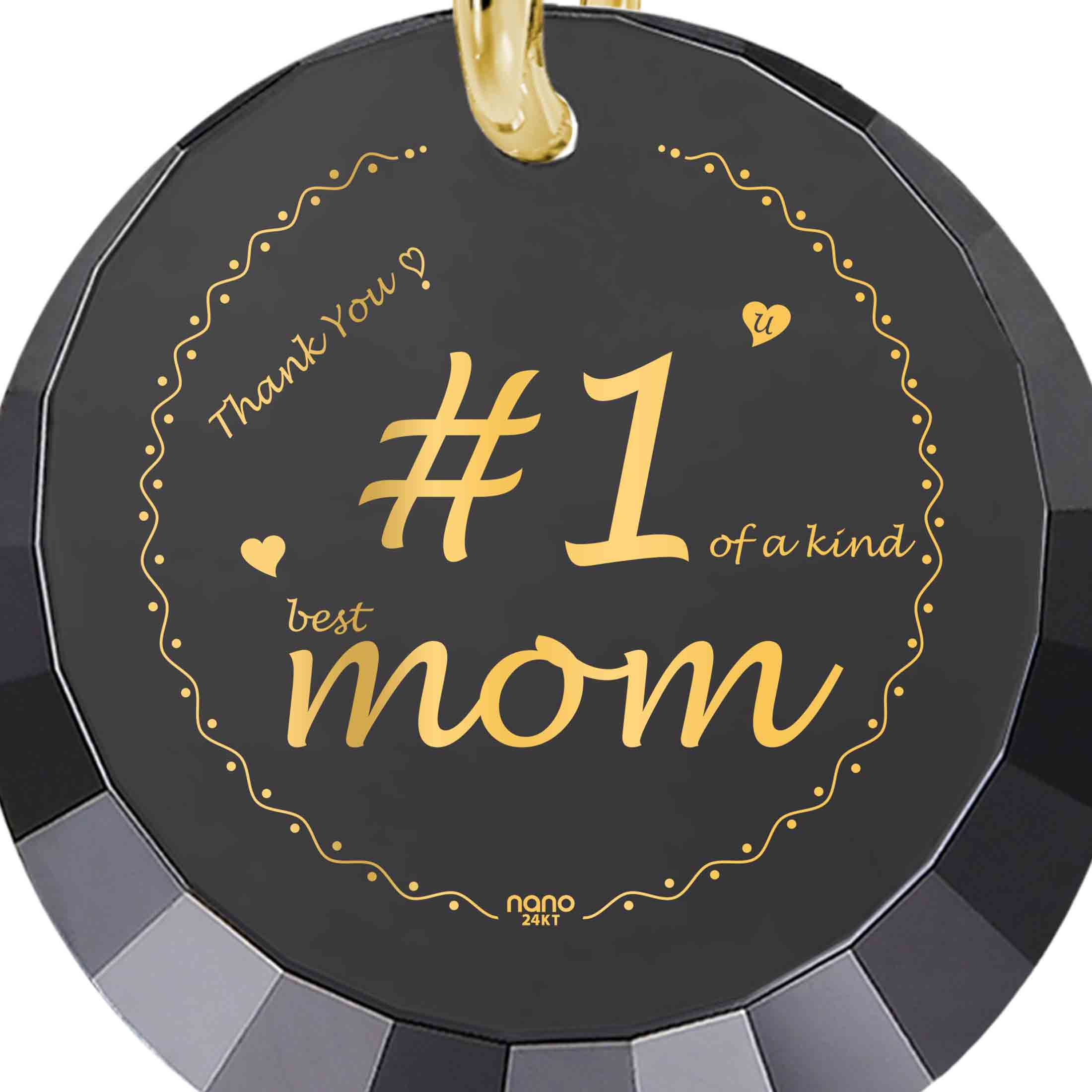 Round pendant with "Number One Mom" in gold script on a black background, encircled by a golden dotted line and decorative hearts, making it a unique gift.