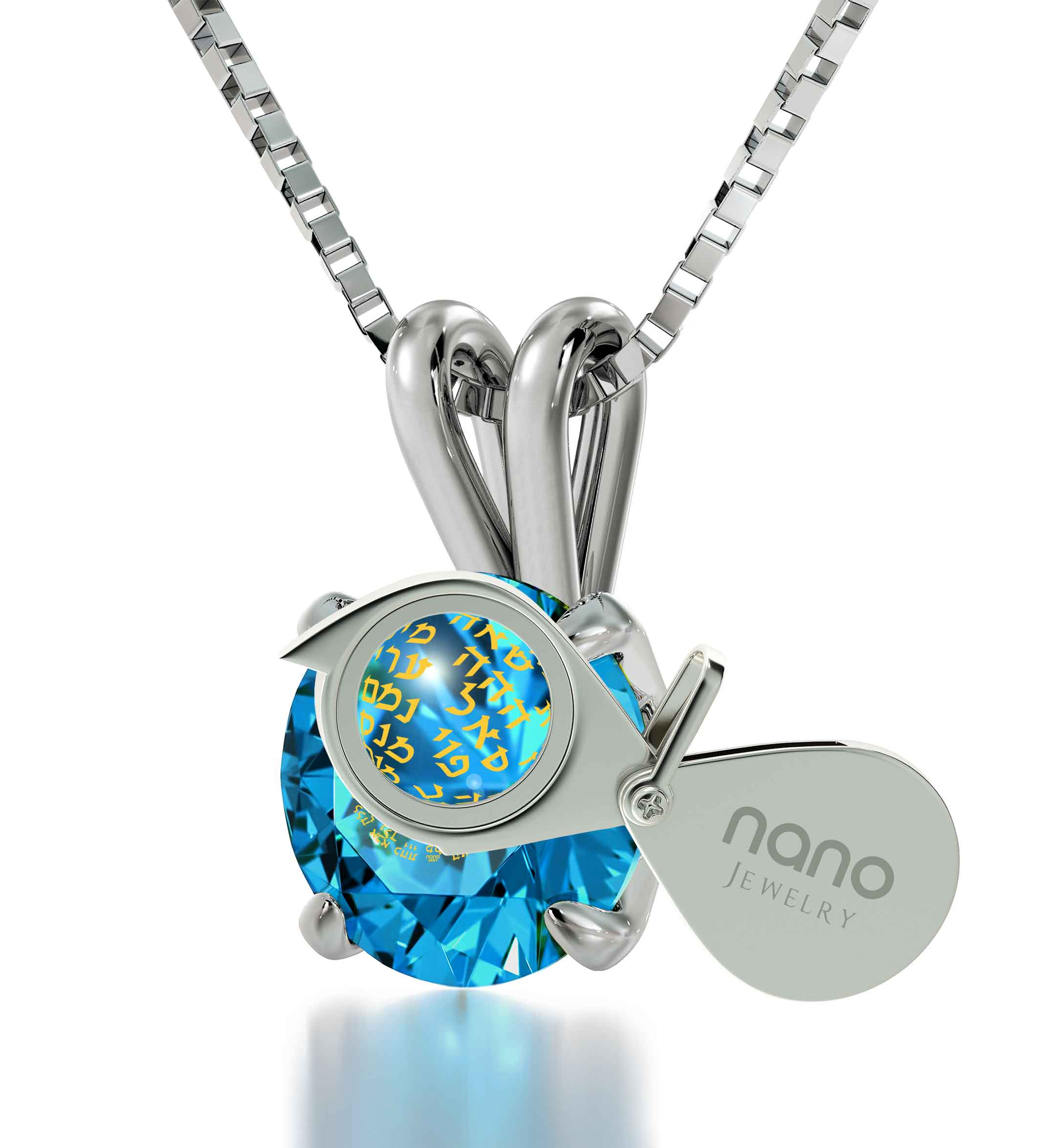 A large blue Swarovski crystal held by a 925 sterling silver claw setting, with intricate golden Hebrew script visible inside the 925 Sterling Silver Kabballah Necklace 72 Names Solitaire Pendant 24k Gold Inscribed.
