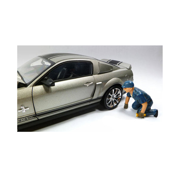 A toy car with a Tow Truck Driver Operator Scott Figure For 1:18 Scale Diecast Car Models by American Diorama working on it.