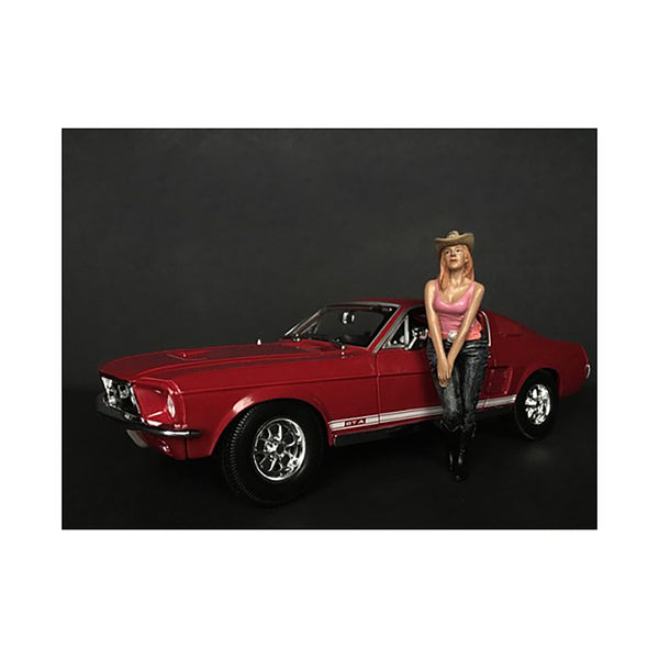 The Western Style Figurine VII for 1/18 Scale Models by American Diorama posing next to a red car.