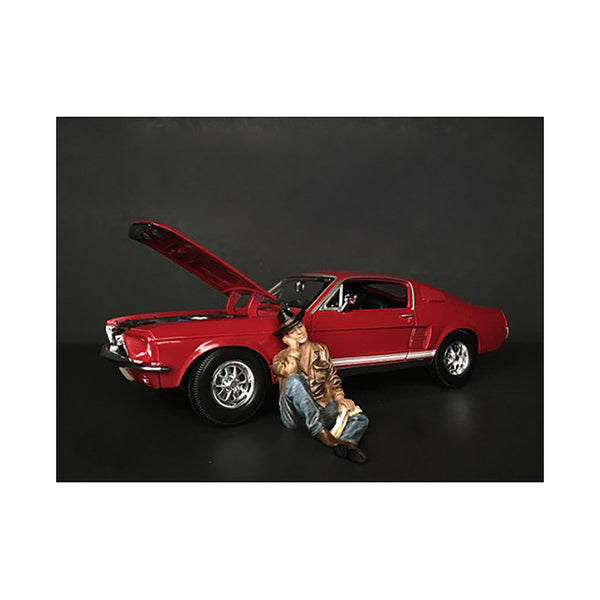 A man sitting next to The Western Style Figurine IV for 1/24 Scale Models by American Diorama.