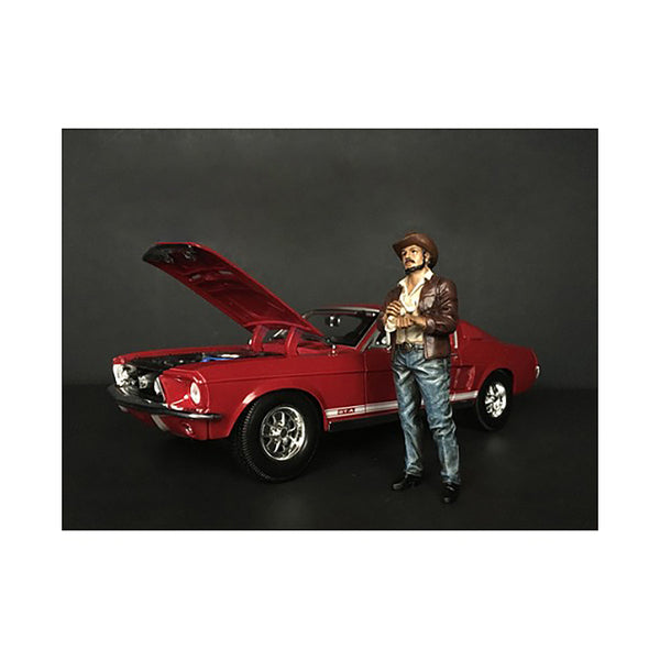 A toy car with The Western Style Figurine VIII for 1/24 Scale Models by American Diorama standing next to it.