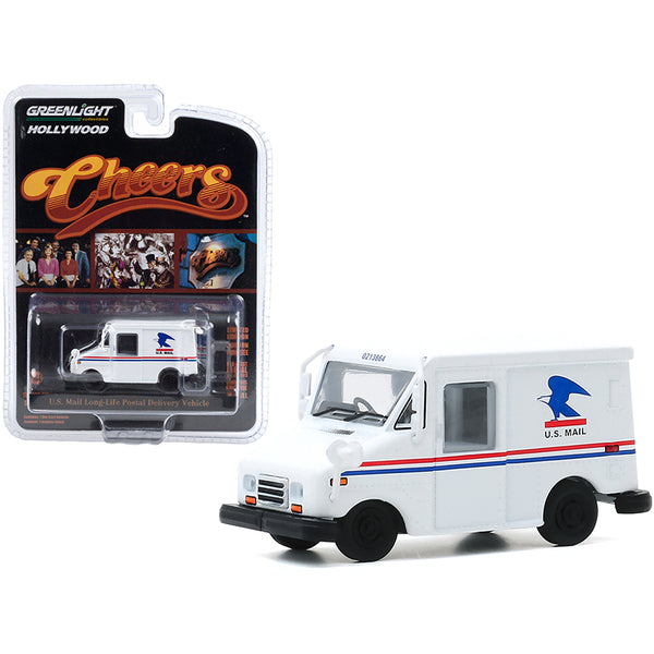 A U.S. Mail Long-Life Postal Delivery Vehicle (LLV) White (Cliff Clavin's) "Cheers" (1982-1993) TV Series "Hollywood Series" Release 29 1/64 Diecast Model Car by Greenlight in front of a package.