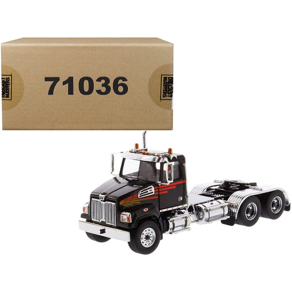 A Western Star 4700 SF Tandem Day Cab Tractor Metallic Black 1/50 Diecast Model by Diecast Masters with a box next to it.