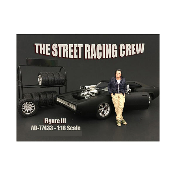 A model of The Street Racing Crew Figure III For 1:18 Scale Models by American Diorama with a man standing next to it.
