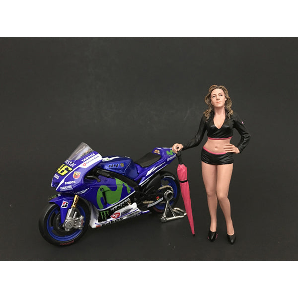 A Umbrella Girl Figurine II for 1/18 Scale Models by American Diorama standing next to a motorcycle.