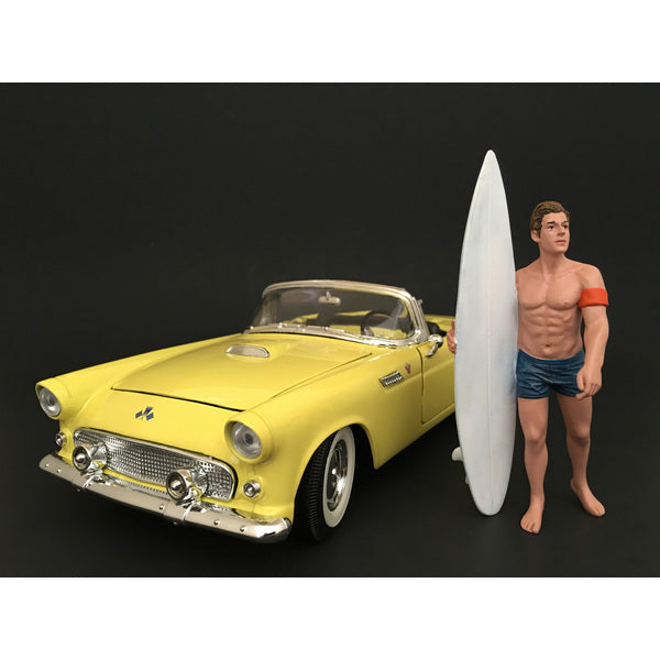 A Surfer Greg Figure For 1:24 Scale Models by American Diorama with a surfboard next to a yellow car.