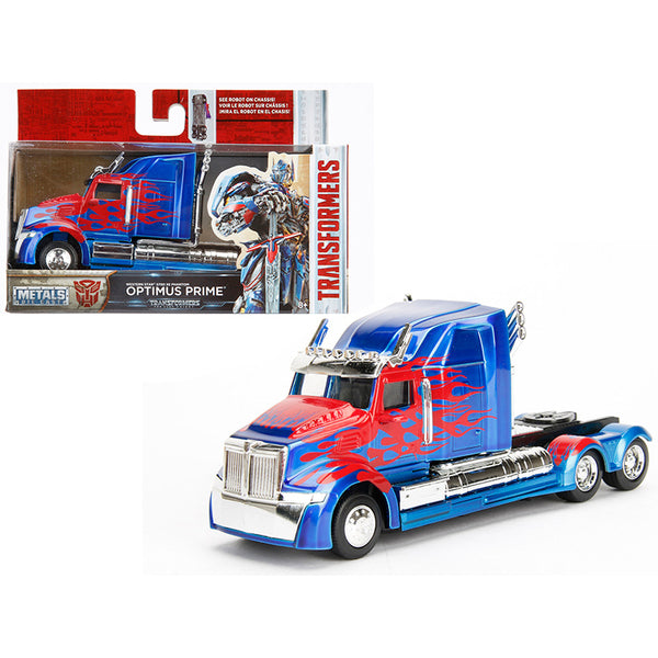 A Western Star 5700 XE Phantom Truck Tractor Optimus Prime "Transformers: The Last Knight" (2017) Movie "Hollywood Rides" Series 1/32 Diecast Model Car by Jada is shown next to a box.