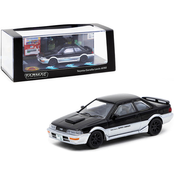 A Toyota Corolla Levin AE92 Black and Silver 1/64 Diecast Model Car by Tarmac Works in front of a box.