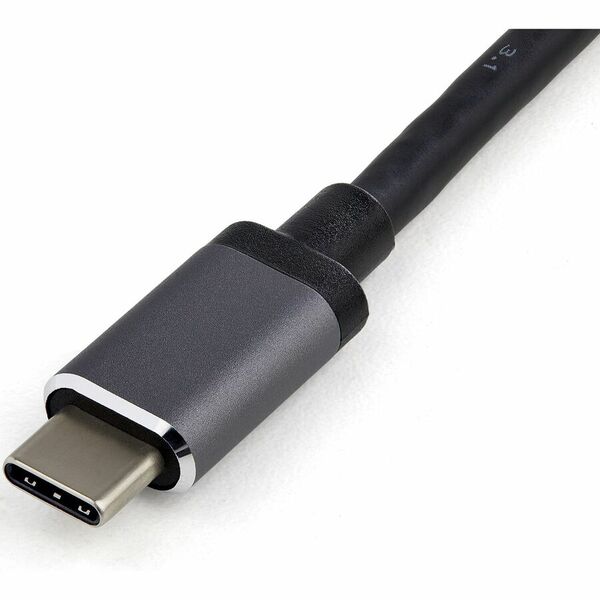 A StarTech.com USB C Multiport Adapter - USB-C Mini Travel Dock w/ 4K HDMI or 1080p VGA - 100W PD Pass-Through, 3x USB, SD, GbE, Audio connected to a computer.