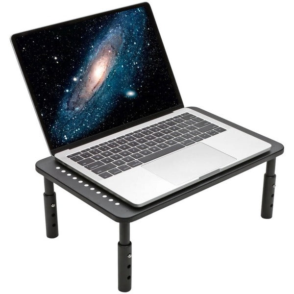 A Tripp Lite Monitor Riser Stand Desktop Metal Height Adjustable Black 14 x 9in with a set of tools on it.