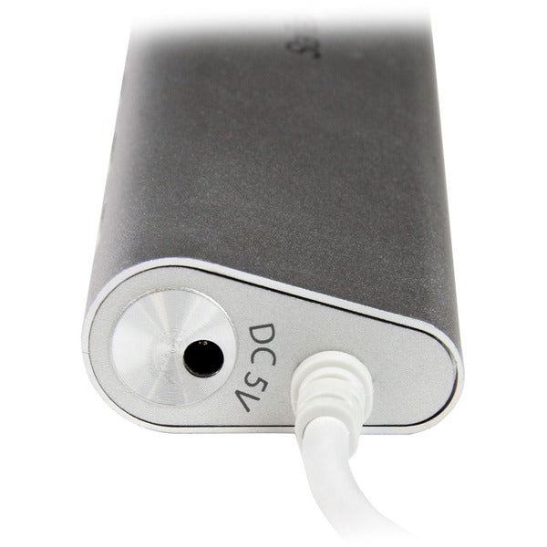 A StarTech.com 7 Port Compact USB 3.0 Hub with Built-in Cable - Aluminum USB Hub - Silver with four usb ports.