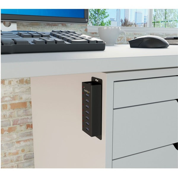 A black StarTech.com 7 Port USB 3.0 Hub - Desktop or Wall-mountable Metal Enclosure with four ports.