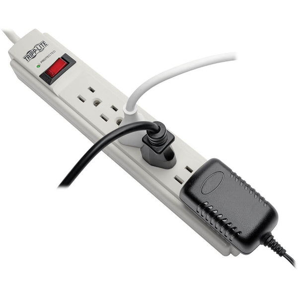 A white Tripp Lite Surge Protector Power Strip 120V 6 Outlet 4' Cord 790 Joule with three outlets.