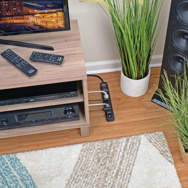 A Tripp Lite Surge Protector Power Strip 6 Outlet 15 ' Cord Black 790 J with two outlets on it.