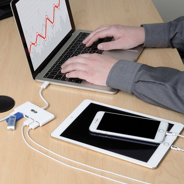 Two Tripp Lite 4-Port USB 3.1 Gen 1 Portable Hubs, USB-C to (x4) USB-A, with USB-C Charging Port on a white surface.