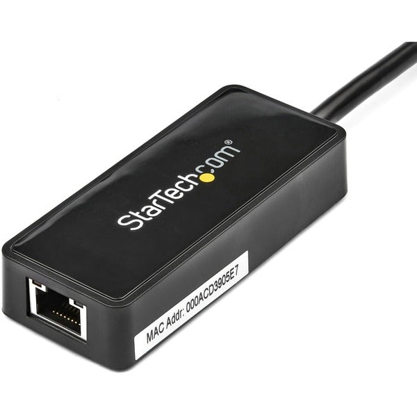 A StarTech.com USB 3.0 to Gigabit Ethernet Adapter NIC w/ USB Port - Black connected to a computer.